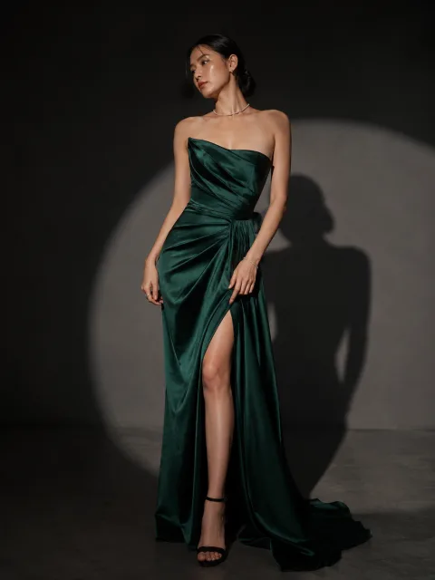 AI model in an emerald evening gown under editorial studio light